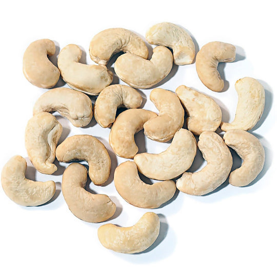 A pile of raw cashew nuts scattered on a plain white background.